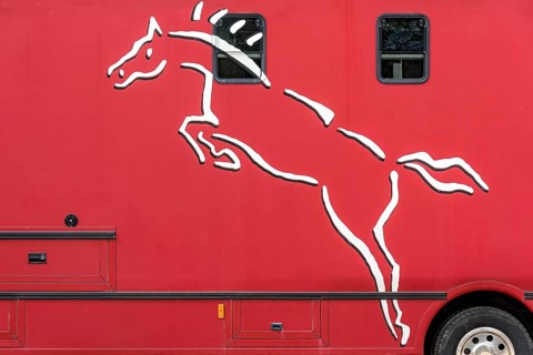 Logo of show horse on horse transporter
