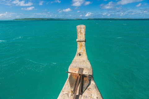 Traditional wood carved boat in the Aitutaki lagoon