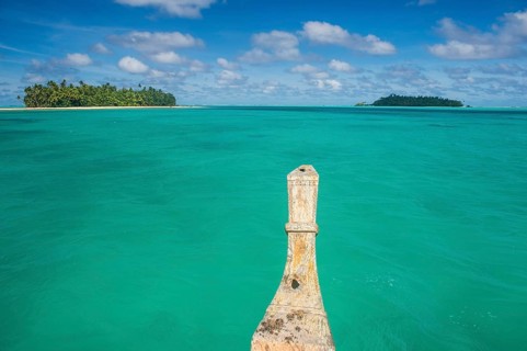 Traditional wood carved boat in the Aitutaki lagoon
