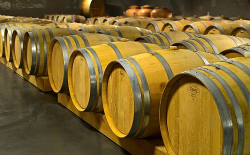 Saury oak barrels with Heida wine in the barrique cellar of the St. Jodern Winery
