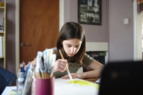 Young teenage girl painting