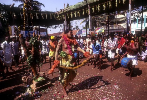 A god possessed man beating himself with whip. Mariamman festival at Coimbatore