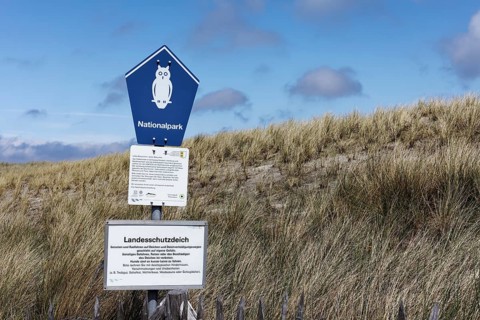 Sign National Park with pictogram Owl in the Schleswig-Holstein Wadden Sea National Park