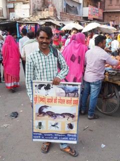 Street vendor presenting a poster