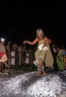 An old woman walking on burning coal