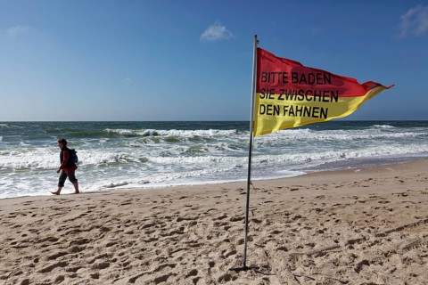 Monitored beach with red-yellow signal flag