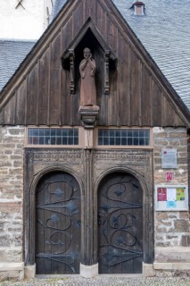 Wooden figure of John the Baptist above the portal of the Protestant St. John's Church in Wernigerode