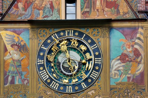 Richly decorated astronomical clock with signs of the zodiac on the town hall
