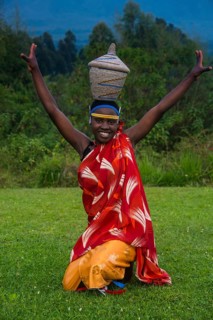 Woman carrying a basket on her hat at a ceremony of former poachers