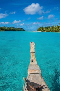 Traditional wood carved boat in the Aitutaki lagoon