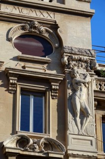 Reliefs of naked woman on the Palazzi degli Ambasciatori Embassy palaces with archway to the Quartiere Coppede