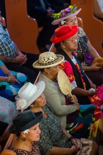 Women with traditional hats on a church service