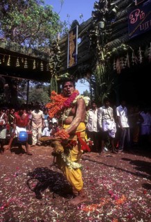 A god possessed man beating himself with whip. Mariamman festival at Coimbatore