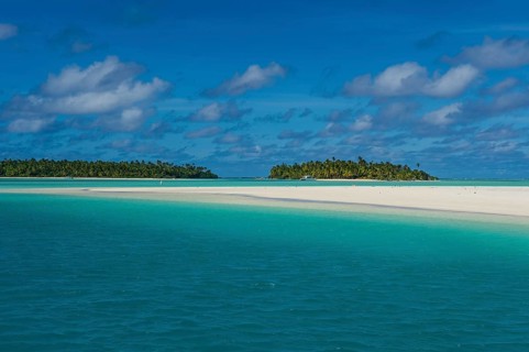 White sand beach and palm fringed beach in Aitutaki lagoon