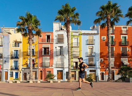 Runner in front of Colorful beachfront houses