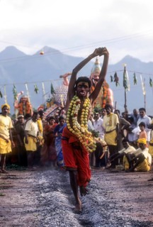 A god possessed man running on burning coal