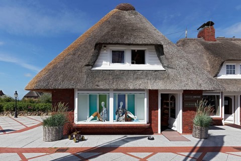 Fashion boutique in house with thatched roof