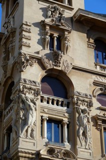 Reliefs of naked woman on the Palazzi degli Ambasciatori Embassy palaces with archway to the Quartiere Coppede