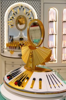 Golden mirror and make-up on a display