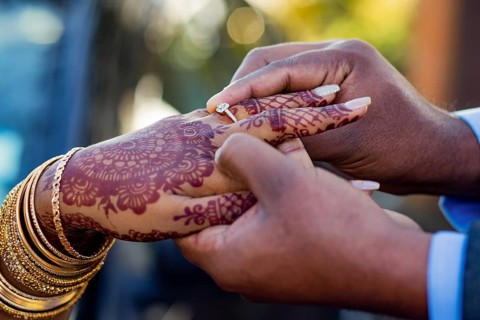 Engagement ring ceremony of a Mauritian Hindu couple. Groom passing ring in his bride`s finger