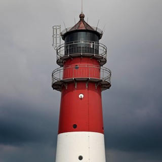 Lighthouse in front of dark clouds
