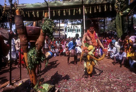 A god possessed man beating himself with whip. Mariamman festival at Coimbatore