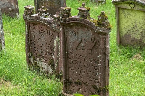 Gravestones with the symbol of the Priests' hands at the historic Jewish Cemetery