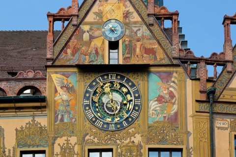 Richly decorated astronomical clock with signs of the zodiac on the town hall