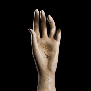 A shop window dummy hand on a black background