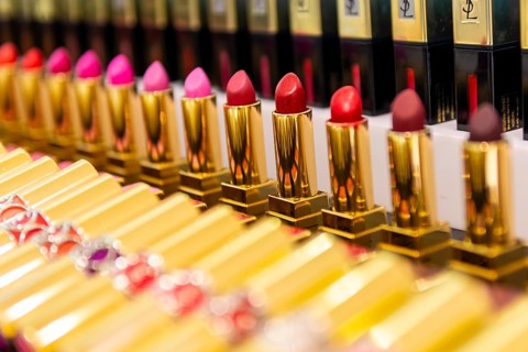 Lined up lipsticks in different shades of red