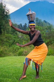 Woman carrying a basket on her hat at a ceremony of former poachers