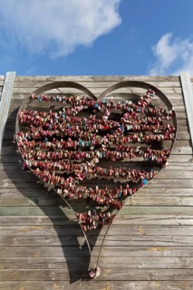 Metal heart filled with love locks