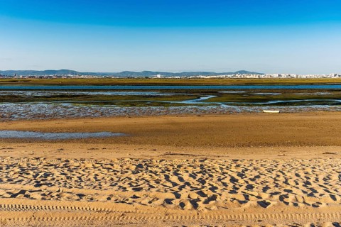 City of Faro seen from Faro Beach Peninsula with wetlands of Ria Formosa in between