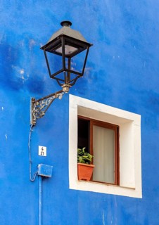Close-up of streetlight and window of blue fishermen's house in Villajoyosa