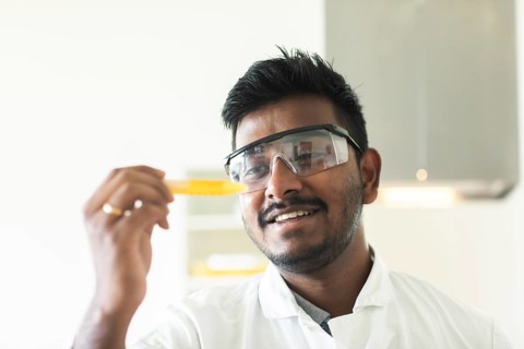 Student in an internship at the university with sample and lab coat