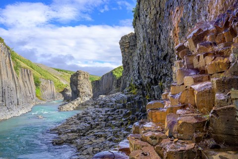 Basalt columns coloured orange by iron oxide