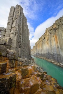 Basalt columns coloured orange by iron oxide