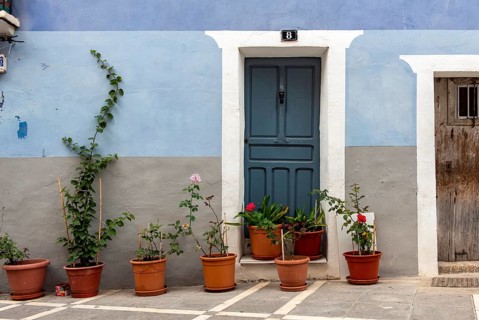 Blue door and house with flowerpots