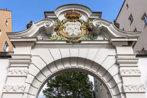 Royal coat of arms above a gateway