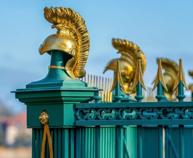 Restored fence with gold helmets at the Lake Grienerick obelisk in Rheinsberg
