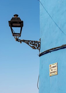 Close-up of streetlight and blue wall
