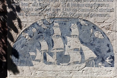 Historical grave slab with sailing ship and inscription
