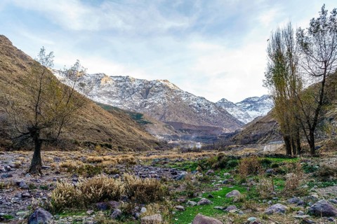 Beautiful valley with stream in Atlas mountain by sunset