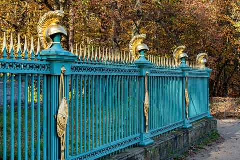 Restored fence with gold helmets at the Lake Grienerick obelisk in Rheinsberg
