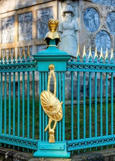 Restored fence with gold helmets at the Lake Grienerick obelisk in Rheinsberg
