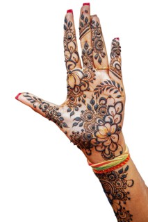Hand of Hindu bride painted with hennas isolated on white background
