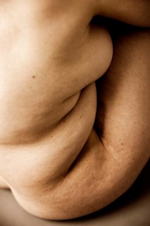 Wrinkled body of a seated naked