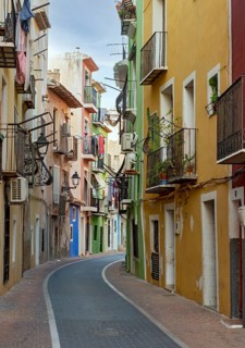 Narrow street with colorful houses in seaside town of Villajoyosa