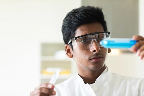 Student in an internship at the university with sample and lab coat