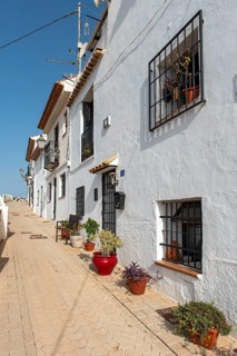 Colorful flowerpots outside white houses of Altea Old Town